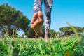 Closeup of woman walking barefoot on the green grass. Barefoot running in the park Royalty Free Stock Photo