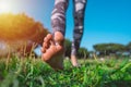 Closeup of woman walking barefoot on the green grass on a sunny summer day. Barefoot running in the park Royalty Free Stock Photo