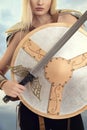 Closeup woman warrior with shield and sword