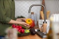 Closeup of woman washing fresh ripe vegetables in kitchen Royalty Free Stock Photo