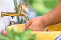 Washing Hands at Brass Faucet