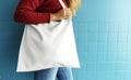 Closeup of woman with white tote bag