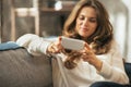 Closeup on woman writing sms in loft apartment Royalty Free Stock Photo