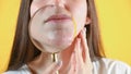 Closeup of a woman's chin with rashes through a magnifying glass. Aleergy and acne concept.
