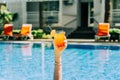 Closeup woman& x27;s hand sticking out of swimming pool holding tropical cocktail. Cropped girl& x27;s female& x27;s hand Royalty Free Stock Photo