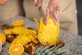 Closeup of a woman& x27;s hands cutting a pineapple Royalty Free Stock Photo