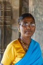 Closeup of woman in yellow-blue sare at Brahma Jinalaya temple, Lakkundi, Karnataka, India