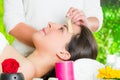 Closeup womans face receiving facial hair waxing treatment, hand using wooden stick to apply wax, beauty and fashion Royalty Free Stock Photo