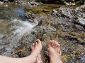 Closeup of womans feet, hardening in a cold mountain brook Royalty Free Stock Photo