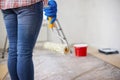 Closeup of womans hand holding paint roller, ready to paint walls of room Royalty Free Stock Photo