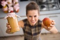 Closeup of womans hands holding apple sauce and fresh apple Royalty Free Stock Photo