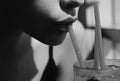 Closeup of womans lips drinking with pink straw. Woman drink cocktail. Close up wet sexy lips. Royalty Free Stock Photo