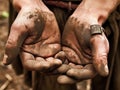 A closeup of a womans worn and weatherbeaten hands gripping onto a few coins all she has remaining to survive after Royalty Free Stock Photo