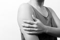 Closeup women arm and shoulder pain/injury with white backgrounds, healthcare and medical concept - B&W filter