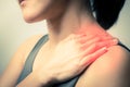 Closeup women neck and shoulder pain/injury with red highlights on pain area with white background, healthcare and medical concept Royalty Free Stock Photo