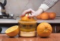 Closeup on womenÃ¢â¬â¢s hand making fresh orange juice. Female hand squeezing orange juice. Juicing orange Royalty Free Stock Photo