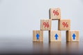 Closeup wood cubes with percentage symbol, Percent and upwards increasing arrows on wooden cubes. Financial interest mortgage