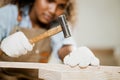 closeup wood worker carpenter use hammer tool with nails for handmade wooden furniture in workshop Royalty Free Stock Photo