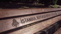 Closeup of wooden bench in park with "The Istanbul Metropolitan Municipality" inscription in Turkish