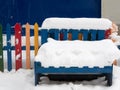 Closeup of wooden bench under huge snowdrift Royalty Free Stock Photo