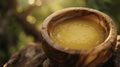 A closeup of a wooden bowl filled with a homemade salve made from natural ingredients such as beeswax and infused oils Royalty Free Stock Photo