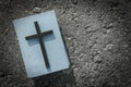 Closeup of wooden christian cross and bible on the grunge background.