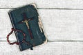 Closeup of wooden christian cross and bible on the old wooden background.