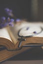 Closeup of wooden Christian cross necklace next to holy Bible Royalty Free Stock Photo