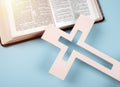 Closeup of wooden Christian cross on open holy bible Royalty Free Stock Photo