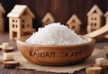 Closeup of wooden cubes with text Zakat on wooden bowl with rice grain and mini house on the background. Islamic zakat concept Royalty Free Stock Photo