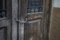 Wooden door of an old house that is closed with a padlock and chain Royalty Free Stock Photo