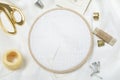 Closeup of wooden embroidery frames, scissors, threads, thimbles, needles, and clean white fabric for embroidering.Empty space for