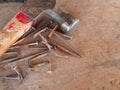 Closeup of a wooden hammer and rusty nails on a wooden surface Royalty Free Stock Photo