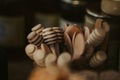 Closeup of wooden honey spoons in a container with a blurry background Royalty Free Stock Photo