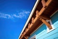 closeup of wooden overhanging eaves on craftsman house with blue sky