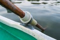 Closeup of wooden paddle locked on gunwale Royalty Free Stock Photo