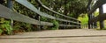 Closeup of a wooden path with a fence in nature Royalty Free Stock Photo