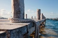 Closeup of wooden pier, blue water,boat rope Royalty Free Stock Photo