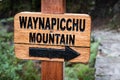 Closeup of wooden pointing sign to Waynapicchu mountain Royalty Free Stock Photo