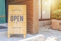 Closeup Wooden sign placed in front of the shop is labeled WELCOME Come on in We`re OPEN Royalty Free Stock Photo