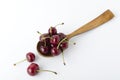 Closeup of wooden spoon full of ripe cherries on the white background Royalty Free Stock Photo