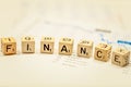 Closeup of word Finance on wooden blocks on stock chart Royalty Free Stock Photo