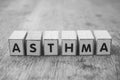 word on wooden cube on wooden desk background concept - Asthma