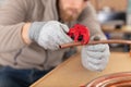 closeup worker cutting copper pipe