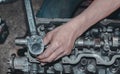 Closeup of a worker fixing an internal combustion engine Royalty Free Stock Photo