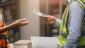 Closeup worker hand receiving cash money from paying person for salary bonus pay off debt or graft concept