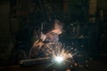 Closeup worker in a mask doing the welding in a workshop Royalty Free Stock Photo