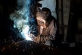 Closeup worker in a mask doing the welding in a workshop Royalty Free Stock Photo