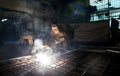 Closeup worker in a mask doing the welding in a workshop Royalty Free Stock Photo