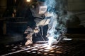Closeup worker in a mask doing the welding in a workshop Royalty Free Stock Photo